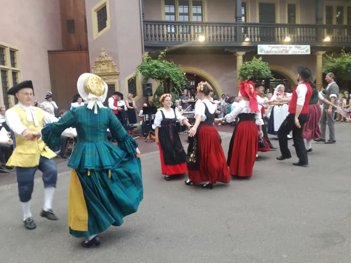 Folklore dancing in the evening at Colmar, Alsace (France)